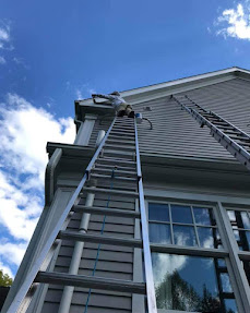Exterior siding painting with ladders